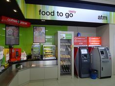 an atm machine sitting inside of a food court