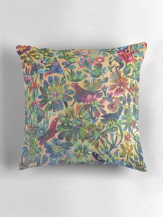 a colorful pillow with birds and flowers on it