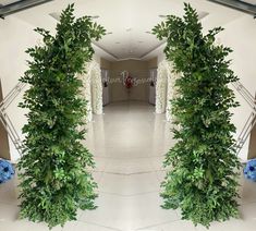 an image of the inside of a building with flowers and greenery on either side