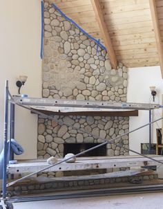 a stone fireplace being built in a living room