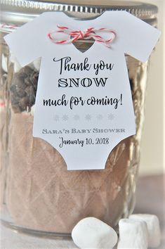 a jar filled with marshmallows and a thank you snow label on it