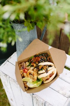 an open take out box sitting on top of a wooden table