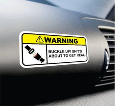 a warning sticker on the dashboard of a car