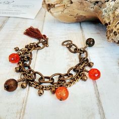 This Unique Agate Multi Chain bracelet is handmade with love from Greece. It's a fashionable piece of art, which combines beautiful wire wrapped agate gem stones in various shades of orange, framed with antique bronze chains, metal beads and a textured toggle clasp. Moreover, a playful brown cotton tassel completes this bohemian style piece of art. That perfect match of colors along with the healing properties of agate crystals, make this bracelet an ideal gift choice for yourself or a friend an Multi Chain Bracelet, Greek Design, Gems Bracelet, Romantic Jewelry, Agate Bracelet, Agate Crystal, Gem Stones, Short Necklace, Design Jewelry