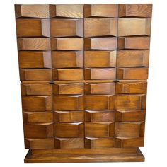 a wooden sculpture with many cubes on it's sides and the top section missing