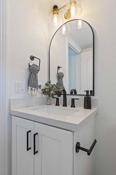 a bathroom with a sink, mirror and lights