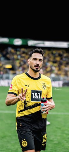 a man in yellow and black soccer uniform on field