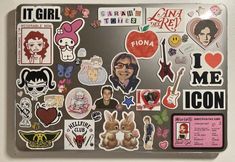 a laptop covered in lots of stickers and magnets