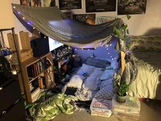 an unmade bed in a dorm room with posters on the wall