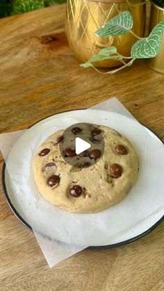 a chocolate chip cookie sitting on top of a white plate