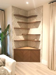 a living room filled with furniture and a wall mounted shelf