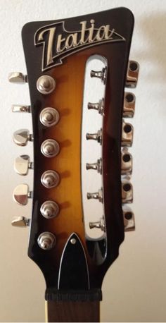 an electric guitar neck with the heads turned upside down