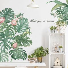 there is a wall mural in the room that has plants and other things on it