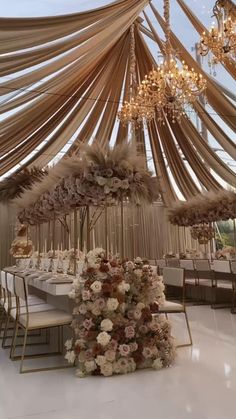 an elegant wedding setup with flowers and chandeliers