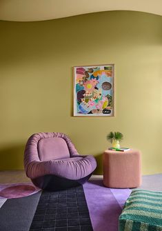 a living room with two chairs and a rug on the floor in front of it