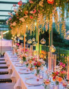 a long table is set up with flowers and candles for an elegant dinner or party