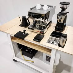 a coffee maker sitting on top of a wooden table