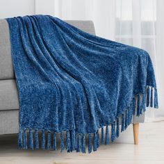 a couch with a blue blanket on top of it