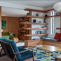 a living room filled with furniture and a fire place in the middle of it's walls