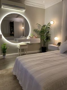 a bedroom with a large round mirror above the bed