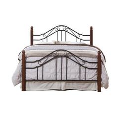 a bed that has a metal frame and white sheets on top of it, against a white background