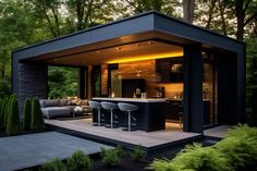 an outdoor kitchen and living area in the woods