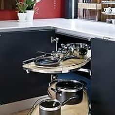 a kitchen with pots and pans sitting on the shelf in front of the stove