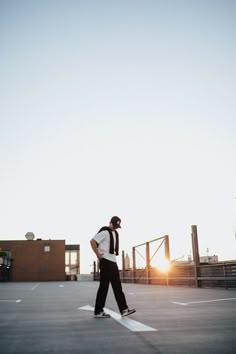 a man riding a skateboard across a parking lot