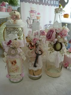 an image of some jars with flowers on them and one has a key in it