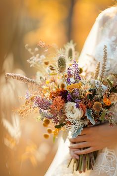 a woman holding a bouquet of flowers in her hands