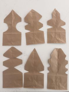 several pieces of brown paper cut into shapes