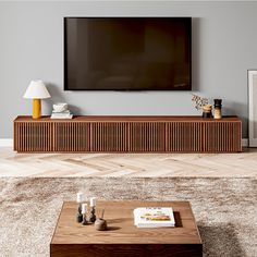 a flat screen tv mounted to the side of a wooden entertainment center in a living room