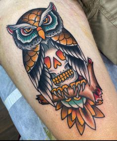 an owl sitting on top of a flower with a skull in it's center