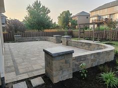 an outdoor patio with stone walls and steps