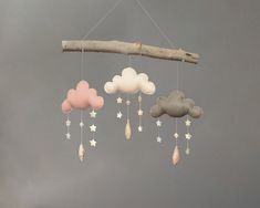 a mobile with clouds and stars hanging from it