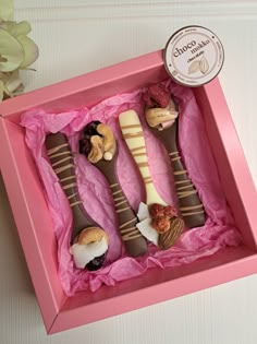 three different types of desserts in a pink box