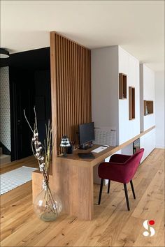 an office with wood paneling and red chairs in the corner, next to a desk