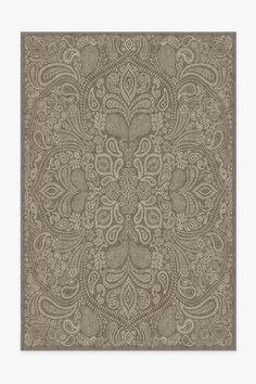 a brown and white rug with an intricate design