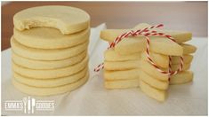 a stack of cookies sitting next to each other on top of a white table cloth