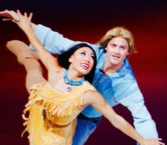 a man and woman dance together on stage