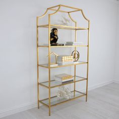 a gold shelf with books and other items on it