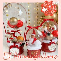 three snow globes with santa claus and other christmas decorations in them on a table