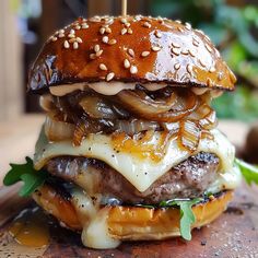 a hamburger with onions, cheese and meat