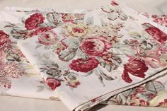 two sheets with red and white flowers on them