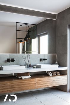 a modern bathroom with two sinks and mirrors