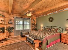 a bedroom with a bed, dresser and television in it