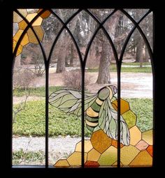 a stained glass window with a bee on it