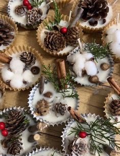 some cupcakes are decorated with pine cones and cinnamon sticks