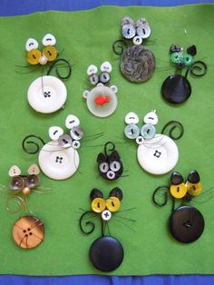 a table topped with lots of different types of buttons on top of a green cloth