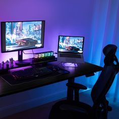 two computer monitors sitting on top of a desk